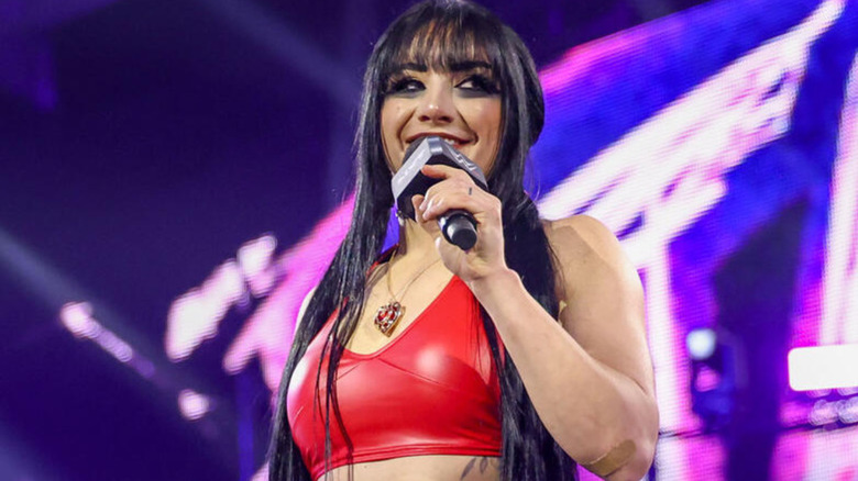 Tatum Paxley holding a microphone