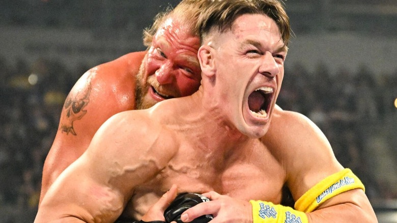 John Cena yells in pain as he attempts to break a hold put on him by Brock Lesnar during their match at Wrestlepalooza.