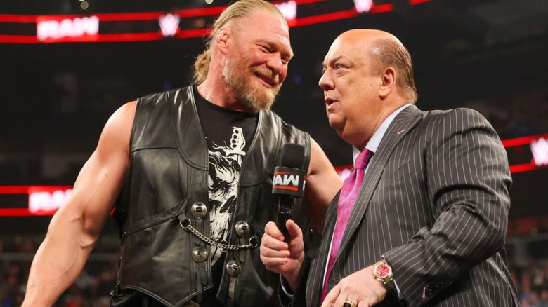 Paul Heyman and Brock Lesnar confer about something in the ring during a promo segment on an episode of 