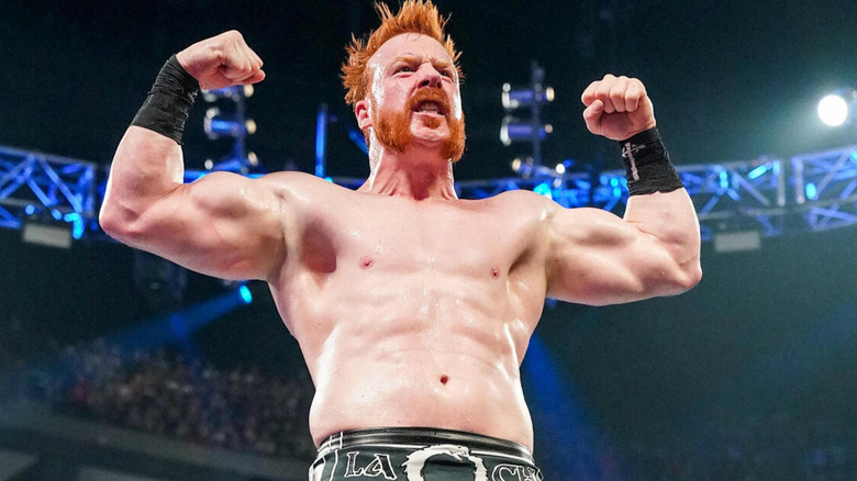 Sheamus flexes, shirtless and in the bright spotlight/