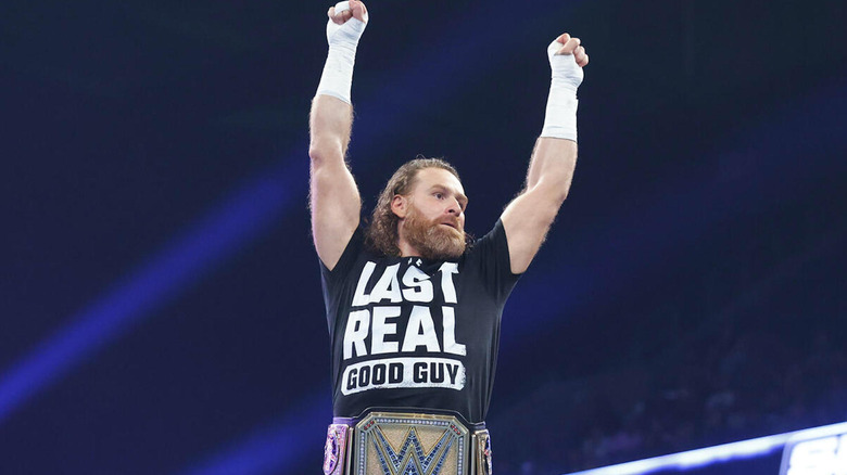 Sami Zayn posing with the WWE Undisputed title