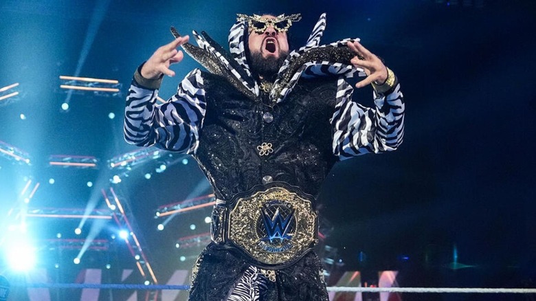 World Heavyweight Champion Seth Rollins poses in the ring, belt around his waist, before his match against Cody Rhodes at WWE Crown Jewel.