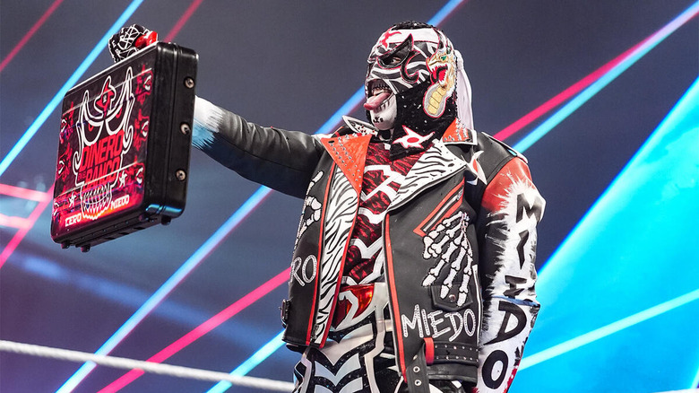 Penta holding the Money in the Bank briefcase on "WWE Raw"