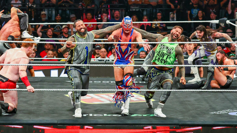 Jey and Jimmy Uso throwing El Grande Americano over the top rope on "WWE Raw"