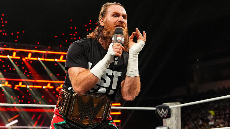 Sam Zayn speaking into a microphone in the ring on "WWE Raw"
