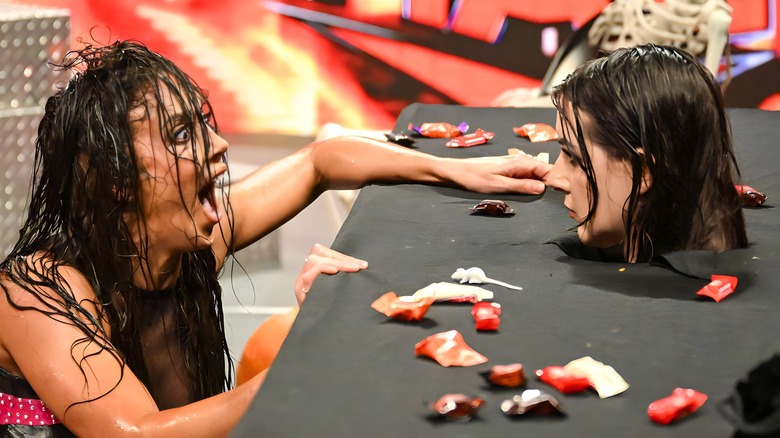 Chelsea Green staring at Nikki Cross' head