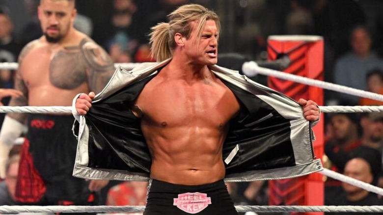 Dolph Ziggler shows off his abs on the ring apron, with Solo Sikoa waiting behind him, before match on "WWE Raw."