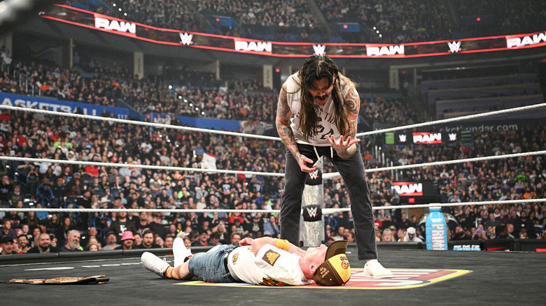 Dominik Mysterio stands over John Wee-na