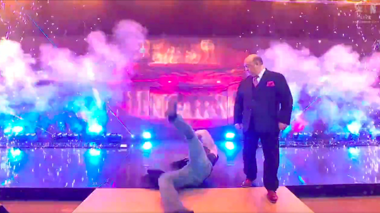 Brock Lesnar slips on the entrance, as Paul Heyman looks on.