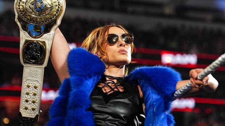 Becky Lynch holds up the Women's Intercontinental Championships as she looks to the fans before a match on "WWE Raw."