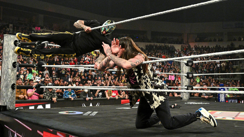 Rey Mysterio winds up for a 619 on Dominik Mysterio.