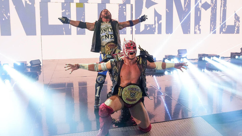 AJ Styles and Dragon Lee pose with their WWE World Tag Team Championships.