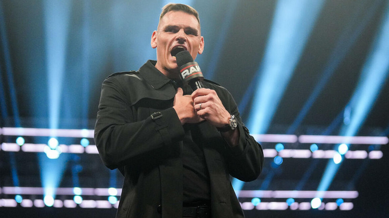 GUNTHER speaks into a microphone on "WWE Raw"