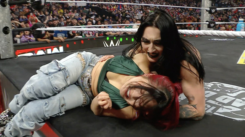 Rhea Ripley clutches a wounded IYO SKY