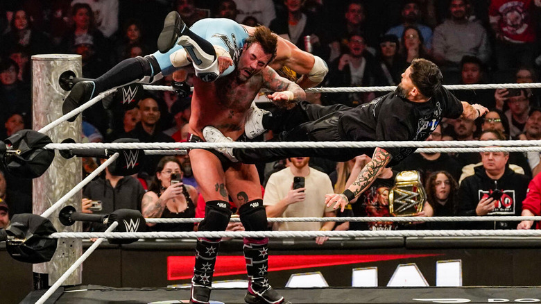 Finn Balor attacks CM Punk with AJ Styles on his shoulders on "WWE Raw"