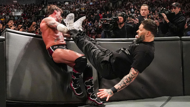 Finn Balor dropkicks CM Punk into the ringside barricade on "WWE Raw"