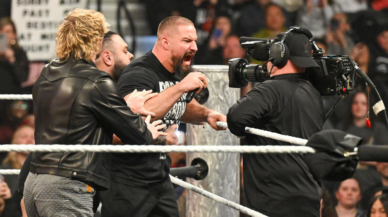 Bron Breakker yells at the camera while his Vision stablemates attempt to hold him back on "WWE Raw"