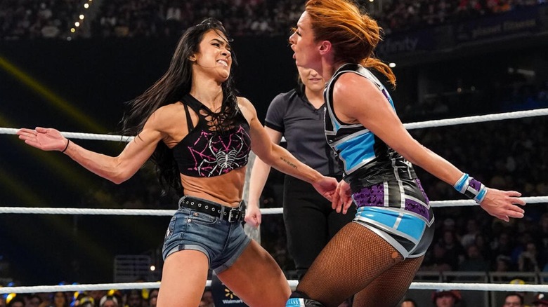 AJ Lee goes to slap Becky Lynch during their mixed tag team match at Wrestlepalooza.
