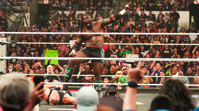 Oba Femi stands on the fallen Brock Lesnar and points on "WWE Raw"