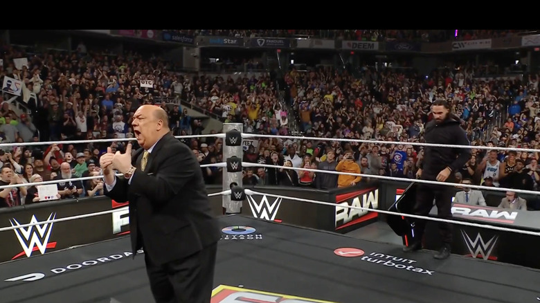 Rollins sneaking up behind Heyman