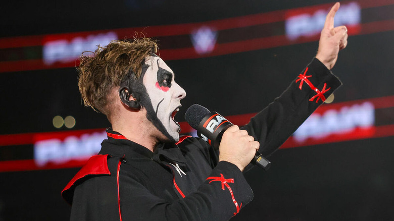 Danhausen with a microphone and a finger in the air on "WWE Raw"