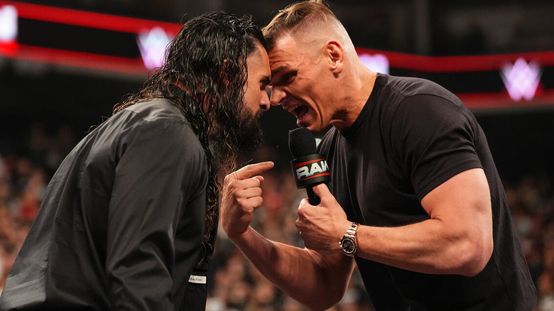 GUNTHER yells into a microphone while going nose to nose with Seth Rollins on "WWE Raw"