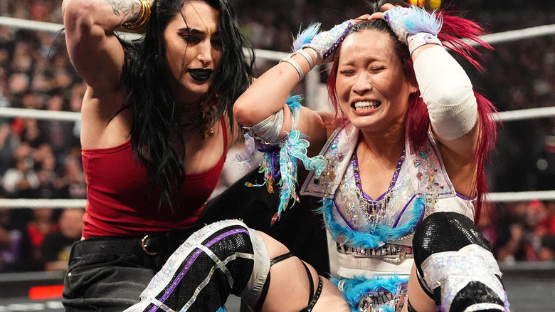 Rhea Ripley and IYO SKY sit dejected in the ring on "WWE Raw"