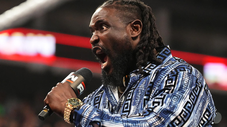 Oba Femi shouting into a microphone on "WWE Raw"