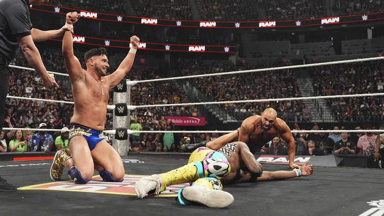 Ethan Page celebrates his "WWE Raw" win over Je'Von Evans while Rusev enters the ring