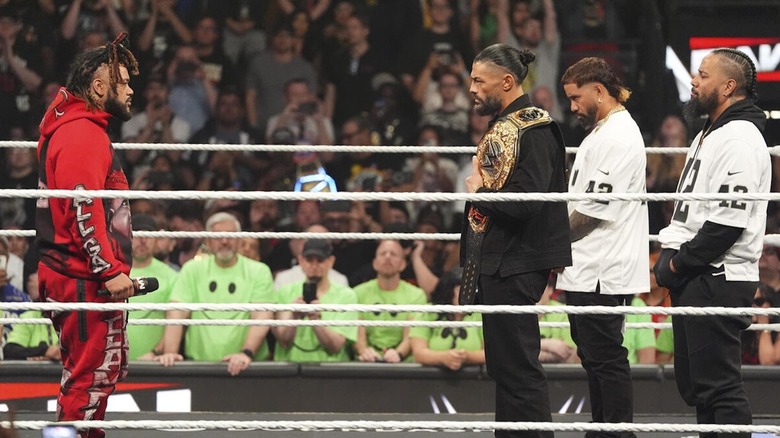 Jacob Fatu stands across the ring from Roman Reigns and the Usos on "WWE Raw"