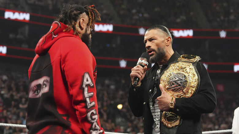Roman Reigns speaking with Jacob Fatu on the microphone on "WWE Raw"