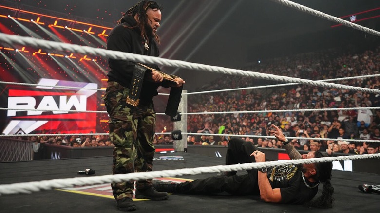 Jacob Fatu stands over Roman Reigns with the World Heavyweight Championship in his hands on "WWE Raw"