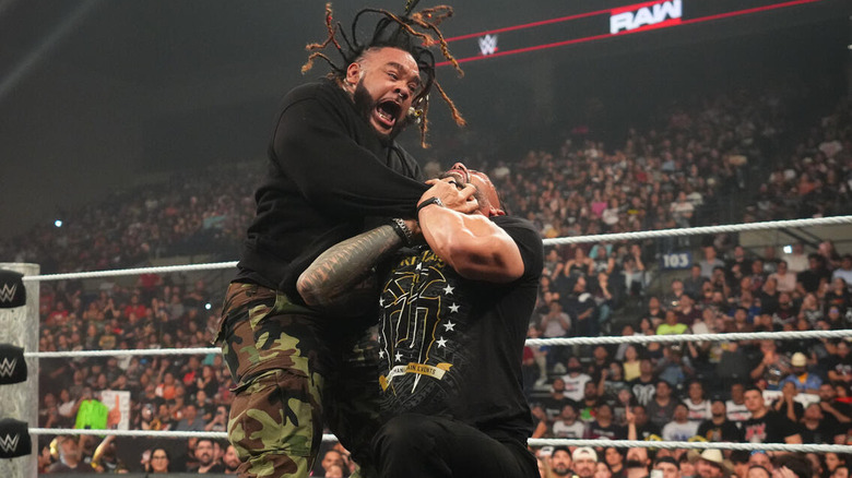 Jacob Fatu applies the Tongan Death Grip to Roman Reigns
