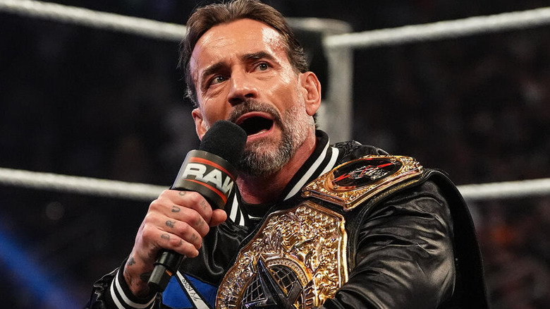 CM Punk speaks into a microphone on "WWE Raw"