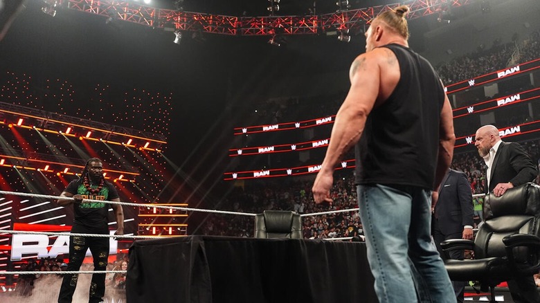 Brock Lesnar stares down Oba Femi across a table on "WWE Raw"