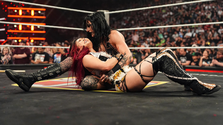 Rhea Ripley cradles the body of IYO SKY on "WWE Raw"