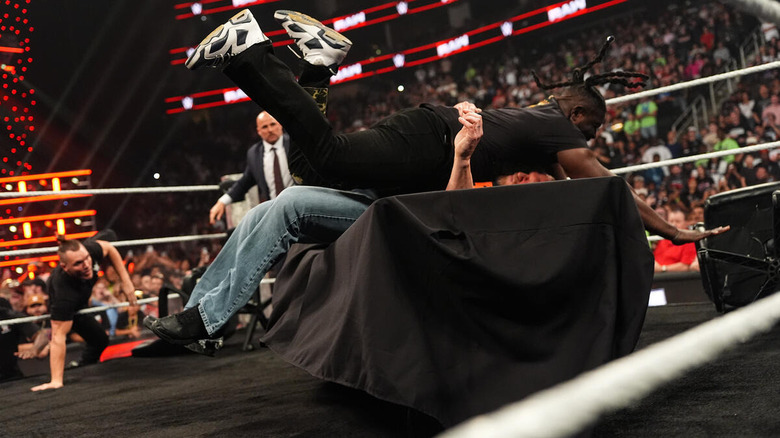 Brock Lesnar and Oba Femi crash through a table on "WWE Raw"