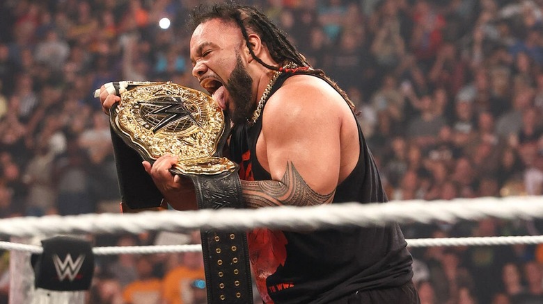 Jacob Fatu licks the World Heavyweight title belt on "WWE Raw"