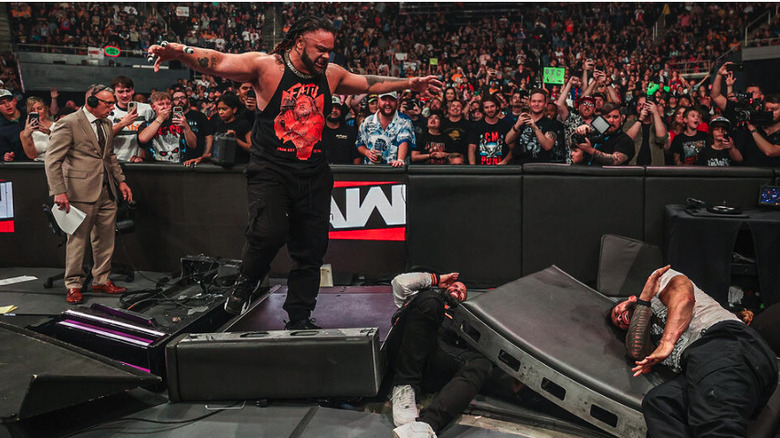 Jacob Fatu stands above the fallen Bloodline amidst smashed ringside barricades on "WWE Raw"