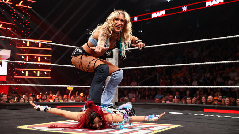 Sol Ruca poses on top of a prone IYO SKY on "WWE Raw"