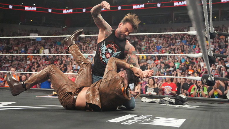 CM Punk hits mounted punches on Seth Rollins on "WWE Raw"