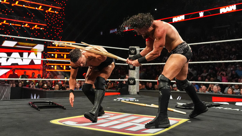 JD McDonagh breaks a kendo stick over the shoulder of Finn Balor on "WWE Raw"