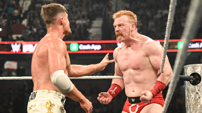 Sheamus (R) stares intensely at Grayson Waller during Monday Night RAW at Bon Secours Wellness Arena on May 19, 2025 in Greenville, South Carolina.