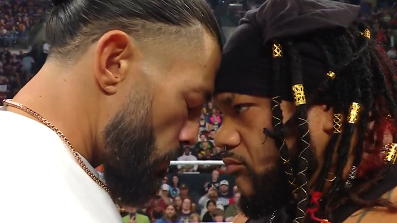 Roman Reigns and Jacob Fatu face off in the ring