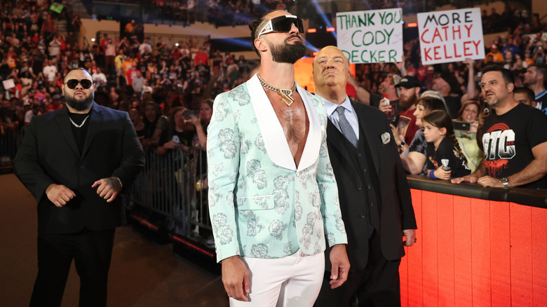 Seth Rollins makes an entrance alongside Bronson Reed and Paul Heyman
