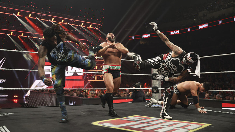 Je'Von Evans and Penta superkick Rusev while Ethan Page crouches nearby on "WWE Raw"