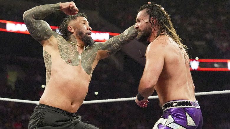 Jey Uso punches Seth Rollins during their match on "WWE Raw"