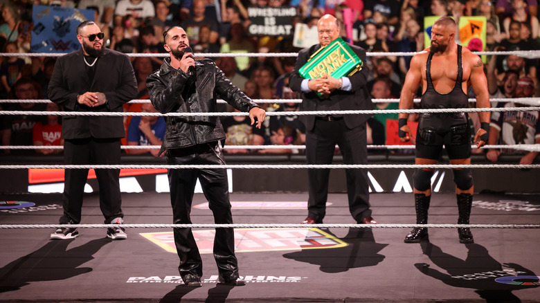 Seth Rollins with Bronson Reed, Paul Heyman (carrying the Money in the Bank briefcase) and Bron Breakker on "WWE Raw"