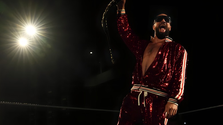 Seth Rollins holds up title