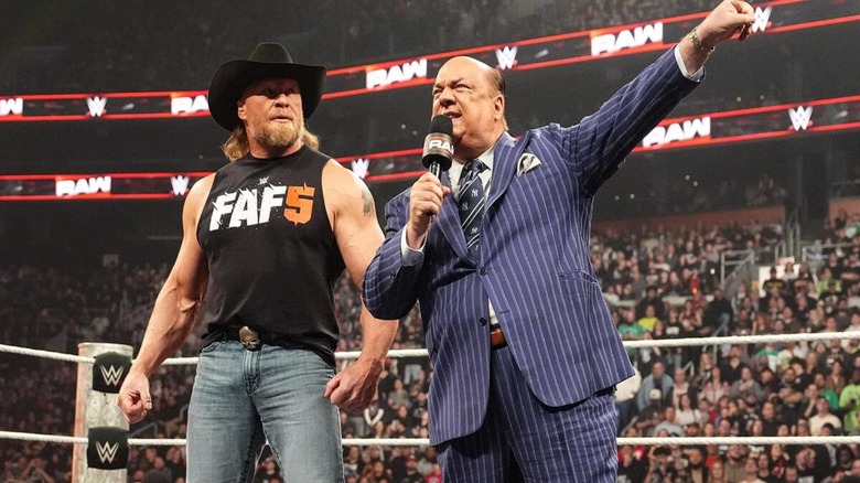 Paul Heyman points to the WrestleMania sign alongside Brock Lesnar in the ring during a promo segment on "WWE Raw."